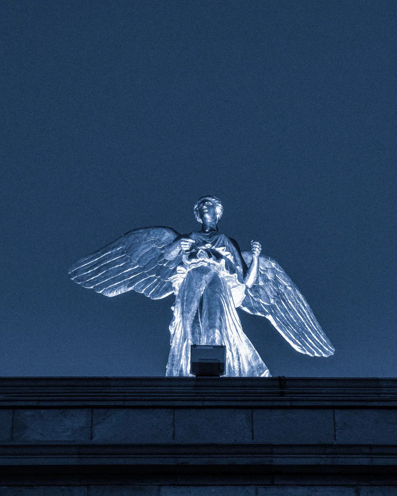 The winged Victory statue lit at night