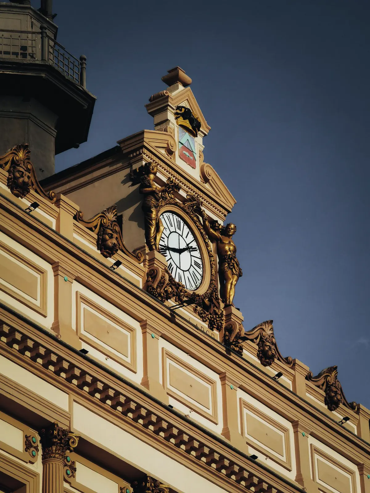 Gilded clock on a historic façade in Constantine